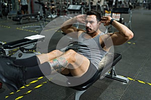 Athletic man training hard at the gym