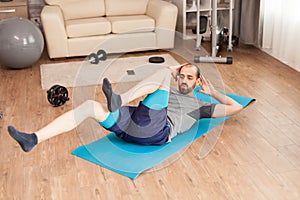 Athletic man training his abdomen