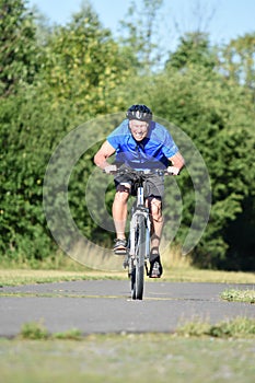 Athletic Man Under Stress Wearing Helmet Biking