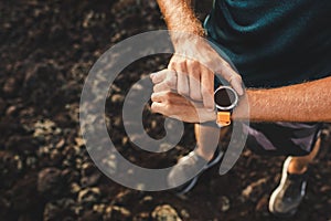 Athletic man using fitness tracker or smart watch