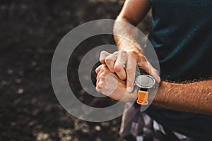 Athletic man using fitness tracker or smart watch