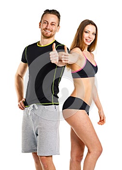 Athletic man and woman after fitness exercise with thumbs up on