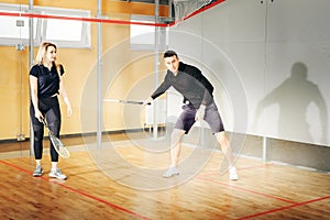 Athletic man and woman playing squash