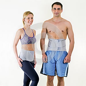 Athletic Man and Woman Wearing Back Support Braces