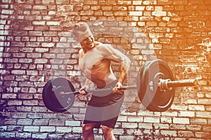 Athletic man working out with a barbell. Strength and motivation