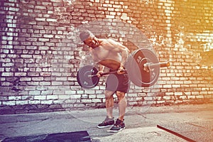 Athletic man working out with a barbell. Strength and motivation