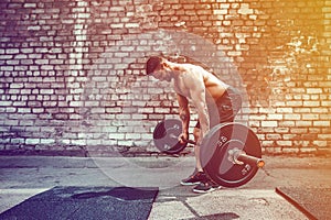 Athletic man working out with a barbell. Strength and motivation