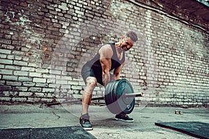 Athletic man working out with a barbell. Strength and motivation. Exercise for the muscles of the back