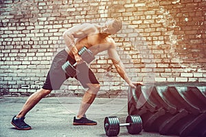 Athletic man working out with a barbell. Strength and motivation. Exercise for the muscles of the back