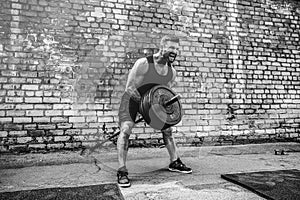 Athletic man working out with a barbell. Strength and motivation. Exercise for the muscles of the back