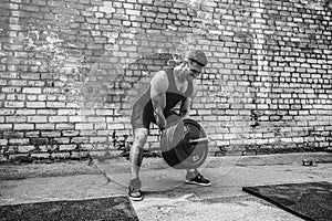 Athletic man working out with a barbell. Strength and motivation. Exercise for the muscles of the back