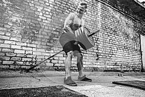 Athletic man working out with a barbell. Strength and motivation. Exercise for the muscles of the back