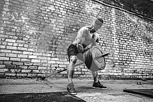 Athletic man working out with a barbell. Strength and motivation. Exercise for the muscles of the back