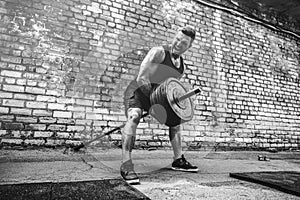 Athletic man working out with a barbell. Strength and motivation. Exercise for the muscles of the back