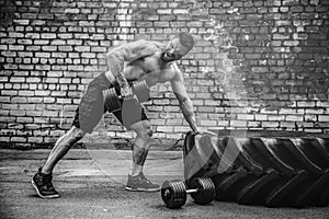 Athletic man working out with a dumbbell. Strength and motivation. Exercise for the muscles of the back