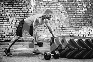 Athletic man working out with a dumbbell. Strength and motivation. Exercise for the muscles of the back