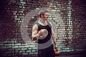 Athletic man working out with a kettlebell. Strength and motivation