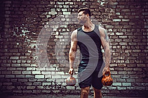 Athletic man working out with a kettlebell. Strength and motivation