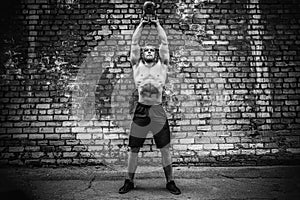Athletic man working out with a kettlebell. Strength and motivation