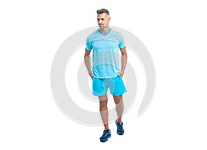 Athletic mature sport man posing. Sport man standing wearing gym sportswear. Handsome sport man after workout in studio