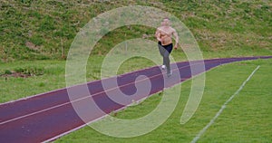 Athletic men with bare torso running outdoors