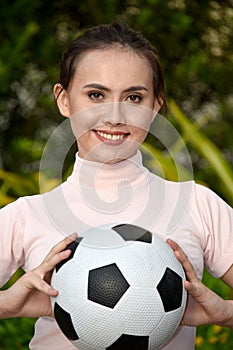 Athletic Minority Female Soccer Player Smiling With Soccer Ball