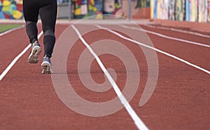 An athletic pair of legs going for a run on a running track