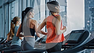 Athletic People Running on Treadmills, Doing Fitness Exercise. Athletic and Muscular Women and Men