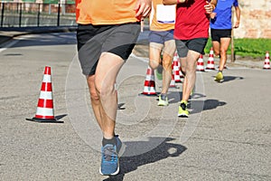 athletic runner with long muscular legs during the foot race