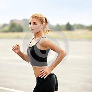 Athletic Runner Training in a park for Marathon. Fitness Girl