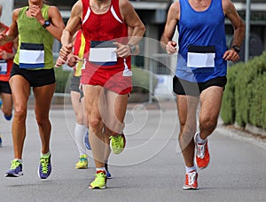 athletic runners during the foot race in the city on the asphalt