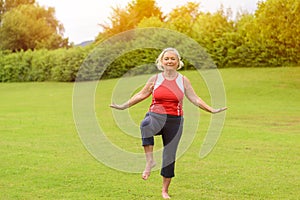 Athletic senior woman performing balance exercises
