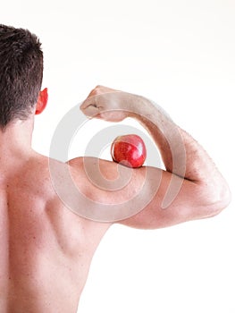 Athletic male body builder holding red apple