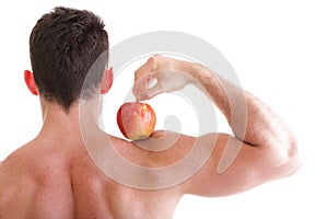 Athletic male body builder holding red apple