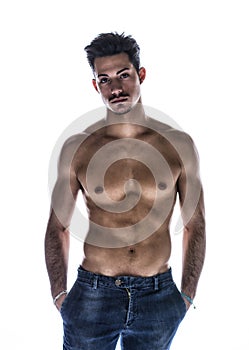 Athletic shirtless young man in jeans, with mustache