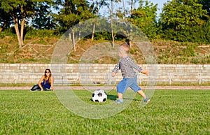 Athletic small boy playing soccer