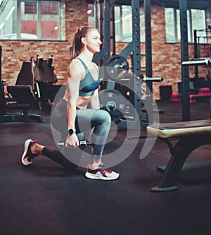 Athletic Smilling Woman Doing Lunges with Dumbbells