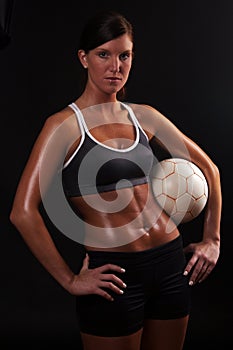 Athletic soccer girl on black