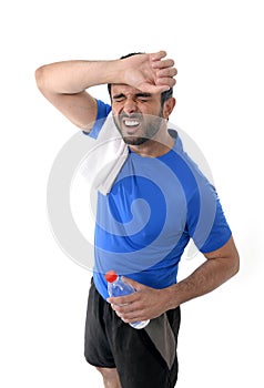 Athletic sport man holding water bottle wiping out sweat after