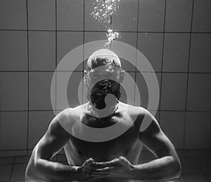 Athletic sport man underwater in the swimming pool.