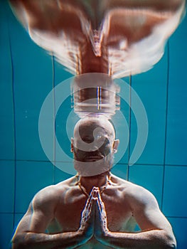 Athletic sport man underwater in the swimming pool.