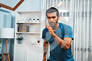 Athletic and sporty man running posture exercise at gaiety home.