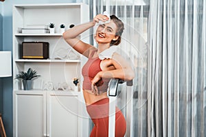Athletic and sporty woman running on treadmill running machine at gaiety home.