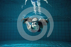 Athletic swimmer smiling at camera underwater