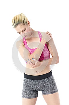 Athletic woman clutching elbow and shoulder