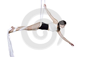 Athletic woman doing some tricks on silks