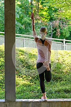 Athletic woman doing warming up exercises