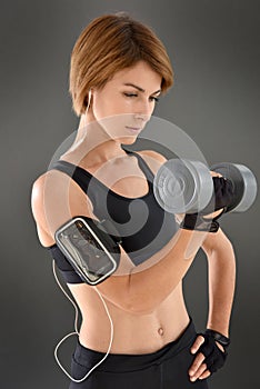 Athletic woman excercising with dumbbells