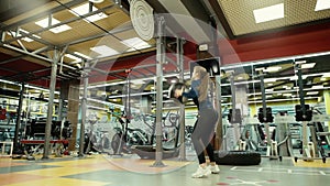 Athletic woman with fitness body exercising with medicine ball at gym in slow mo