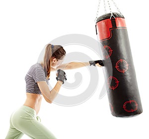 Athletic woman hitting the punching bag